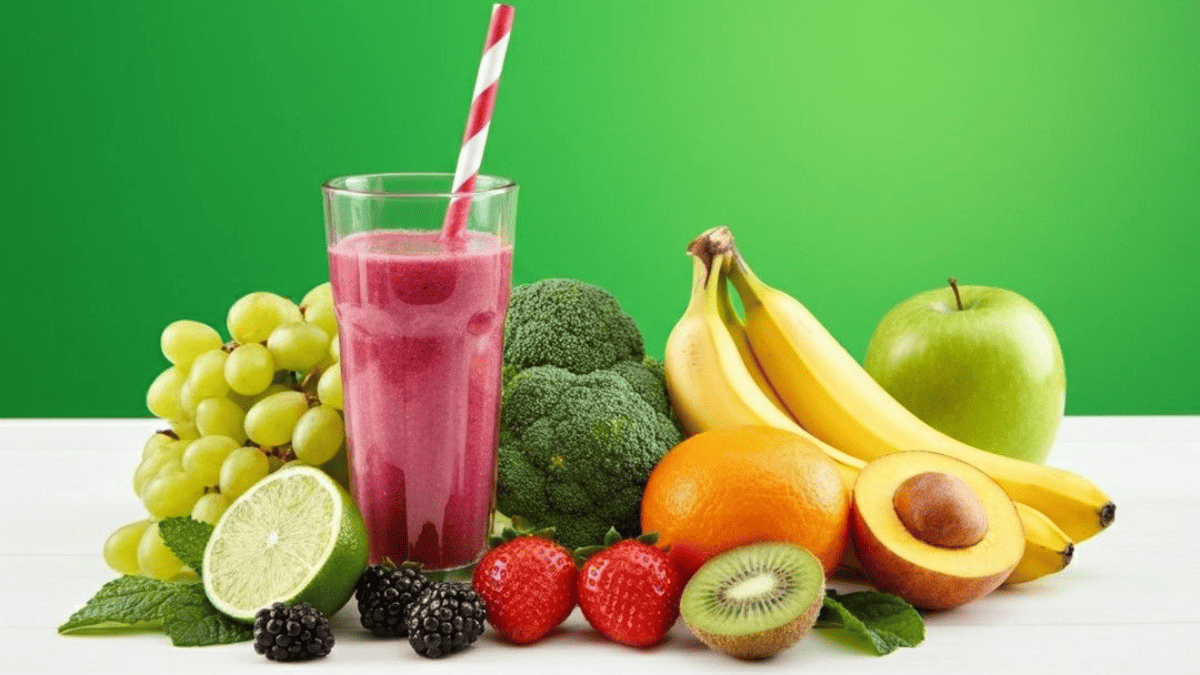 A variety of fresh fruits including apples, bananas, oranges, grapes, berries, and mangoes arranged together.